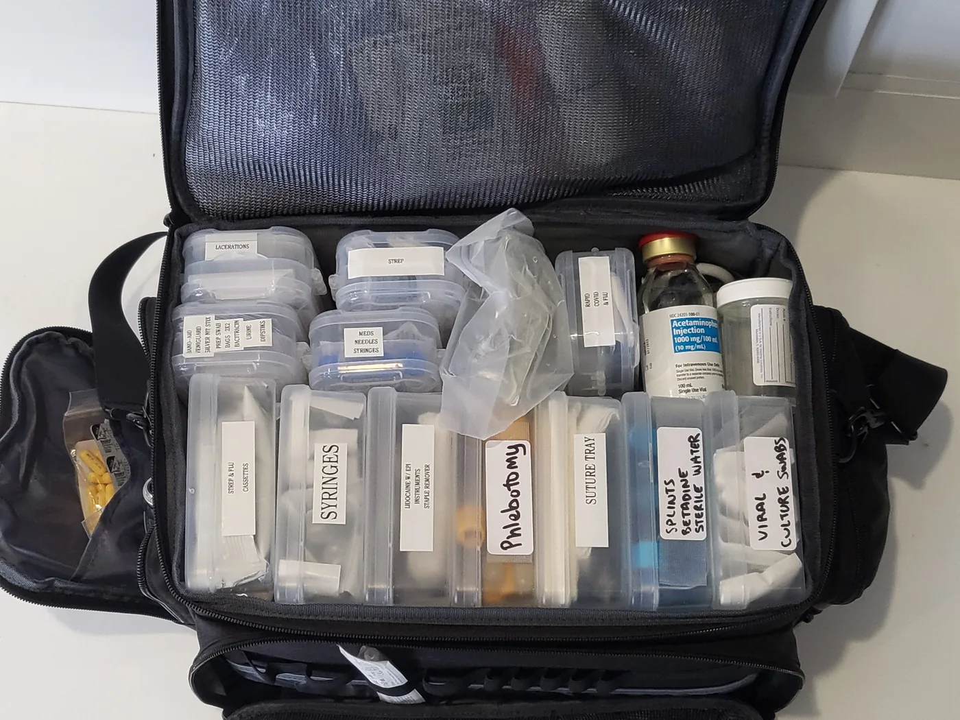 Shalom’s home-visit bag, open and organized with labeled supplies for phlebotomy, swabs and syringes