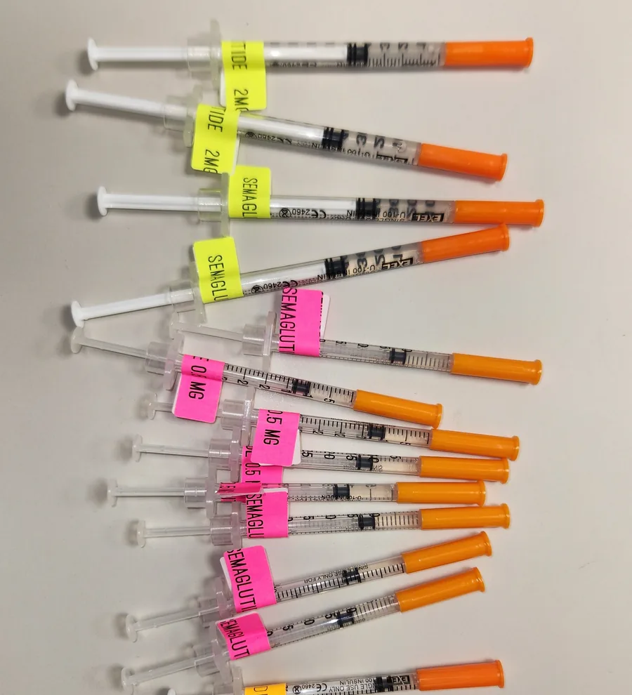 Semaglutide syringes, color-coded and labeled by dose, prepared for patients